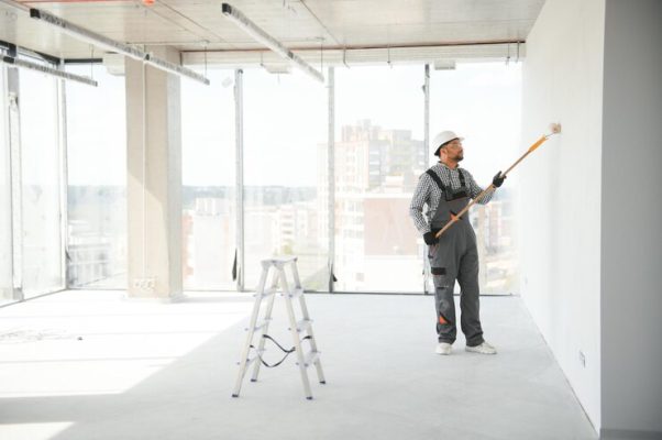 indian apartment repair worker paints white wall with roller indian apartment repair worker paints white wall with roller